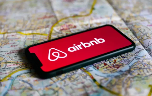 Airbnb logo displayed on a mobile phone