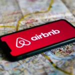 Airbnb logo displayed on a mobile phone