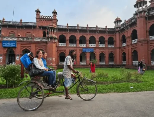 Foreigner traveling on Rickshaw in Dhaka Bangladesh